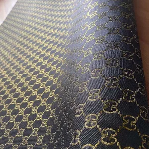 unique black gucci canvas fabric with glittered gold shiny patterns