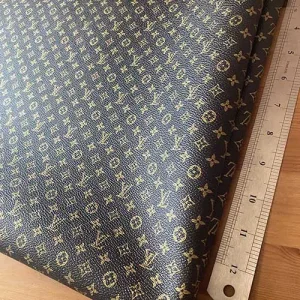 black louis vuitton vinyl leather material with mini gold patterns