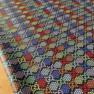 black gucci fabric which has multicolored gucci patterns on